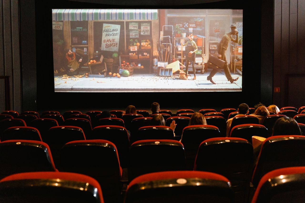 Home A cozy indoor movie theater showing an animated film to a small audience.